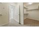 Walk-in closet showing lots of storage space with open door to hallway in neutral colors at 3930 Miller St, Wheat Ridge, CO 80033