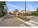 Gated community entrance with decorative brickwork and meticulously landscaped surroundings at 3930 Miller St, Wheat Ridge, CO 80033