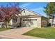Well-maintained home with a two-car garage, lush lawn, and attractive curb appeal with mature trees at 3930 Miller St, Wheat Ridge, CO 80033