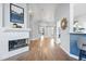 Inviting hallway with a fireplace, arched doorways, and gleaming hardwood floors at 3930 Miller St, Wheat Ridge, CO 80033