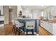 Updated kitchen featuring a breakfast bar with seating, white cabinets, and butcher block counters at 3930 Miller St, Wheat Ridge, CO 80033