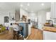 Modern kitchen featuring white cabinets, stainless steel appliances, and an island with bar seating at 3930 Miller St, Wheat Ridge, CO 80033