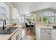 Open kitchen with white cabinets, butcher block countertops, and stainless steel sink at 3930 Miller St, Wheat Ridge, CO 80033