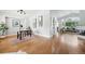 Open-concept living area with hardwood floors, vaulted ceilings, and abundant natural light from large windows at 3930 Miller St, Wheat Ridge, CO 80033