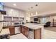 Basement wet bar with granite countertop, microwave, and wine cooler at 11798 Barrentine Loop, Parker, CO 80138