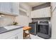 Bright laundry room with washer, dryer, and extra storage at 11798 Barrentine Loop, Parker, CO 80138