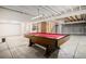 Open basement area with a pool table, exposed ceiling, and concrete floors, ready for customization at 523 E Long Ct, Littleton, CO 80122