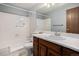 Cozy bathroom featuring a shower and tub combination with neutral tiling and a wooden vanity at 523 E Long Ct, Littleton, CO 80122