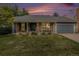 Charming single Gathering home with a manicured lawn, brick facade, and attached garage at 523 E Long Ct, Littleton, CO 80122