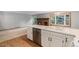 This kitchen features a center island with dishwasher and double basin sink, looking into the Gathering room at 523 E Long Ct, Littleton, CO 80122