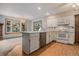 Bright kitchen features updated appliances, a center island, and a view to the backyard at 523 E Long Ct, Littleton, CO 80122