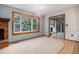 Cozy living room with sliding glass door, decorative chandelier, and a fireplace at 523 E Long Ct, Littleton, CO 80122