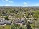 Overhead view of the neighborhood with lush trees and mountain views, showing property's location at 440 Balsam St, Lakewood, CO 80226