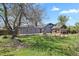 Expansive backyard featuring a patio, shed, and lawn, perfect for outdoor entertaining and relaxation at 440 Balsam St, Lakewood, CO 80226