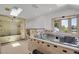 Bright bathroom featuring a whirlpool tub, stand-up shower, and tile flooring at 440 Balsam St, Lakewood, CO 80226