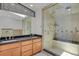 Modern bathroom featuring a glass shower with multiple shower heads and a dual sink vanity at 440 Balsam St, Lakewood, CO 80226