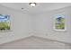 Bright bedroom with white walls, neutral carpet, and two windows at 440 Balsam St, Lakewood, CO 80226