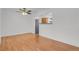 Dining area open to kitchen with wood floors and ceiling fan at 440 Balsam St, Lakewood, CO 80226