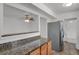 Additional granite countertops, stainless steel refrigerator, and eat-in kitchen at 440 Balsam St, Lakewood, CO 80226
