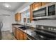 Modern kitchen with granite countertops, stainless steel appliances, and a view from the window at 440 Balsam St, Lakewood, CO 80226