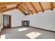 Sunroom featuring beamed wood vaulted ceilings, brick fireplace, and tile flooring at 440 Balsam St, Lakewood, CO 80226