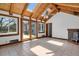 Spacious living room with wood beamed ceilings, skylights, tile floor, and french doors to backyard at 440 Balsam St, Lakewood, CO 80226