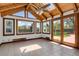 Sunroom with vaulted ceilings, skylights, many windows, and french doors to backyard patio at 440 Balsam St, Lakewood, CO 80226