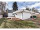 Backyard view showing additional structure, landscaping and fence at 9393 W 14Th Ave, Lakewood, CO 80215