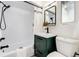 Clean bathroom featuring a tub, shower, and modern vanity at 9393 W 14Th Ave, Lakewood, CO 80215