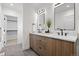 Modern bathroom with double vanity, sleek fixtures, and a spacious walk-in closet for ample storage at 1747 Lowell Blvd, Denver, CO 80204