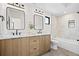 Stylish bathroom featuring a double vanity, modern fixtures, and a shower-tub combo at 1747 Lowell Blvd, Denver, CO 80204