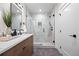 Contemporary bathroom featuring a tiled shower, modern vanity, and elegant design elements at 1747 Lowell Blvd, Denver, CO 80204