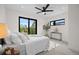 Bright bedroom featuring a modern ceiling fan, balcony access with a view, and stylish décor at 1747 Lowell Blvd, Denver, CO 80204