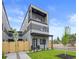 Modern home with two stories, a balcony, well-maintained lawn and decorative fence at 1747 Lowell Blvd, Denver, CO 80204