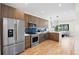 Well-lit kitchen with stainless steel appliances, stylish cabinetry, and open layout at 1747 Lowell Blvd, Denver, CO 80204