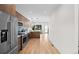Open kitchen view showing modern stainless steel appliances and hardwood flooring at 1747 Lowell Blvd, Denver, CO 80204