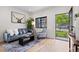 Bright living room featuring hardwood floors, a plush grey sofa and modern decor at 1747 Lowell Blvd, Denver, CO 80204