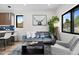 Comfortable living room adjacent to the kitchen with a plush grey sofa at 1747 Lowell Blvd, Denver, CO 80204