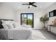 Light-filled main bedroom with a large window and contemporary ceiling fan at 1747 Lowell Blvd, Denver, CO 80204