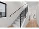 Bright staircase featuring carpeted stairs and wooden floors at 1747 Lowell Blvd, Denver, CO 80204