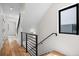 Modern staircase with hardwood floors, black metal railing, and natural light at 1747 Lowell Blvd, Denver, CO 80204