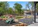 Beautiful backyard with a pond, mature trees, lush landscaping, and a frog statue near the garage at 1051 Independence St, Lakewood, CO 80215