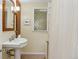 Bathroom with a pedestal sink and decorative glass block shower at 1051 Independence St, Lakewood, CO 80215