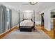 Bright bedroom with hardwood floors, a four poster bed, and ample closet space at 1051 Independence St, Lakewood, CO 80215