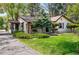 Quaint one-story home with manicured lawn and well-kept landscaping at 1051 Independence St, Lakewood, CO 80215