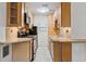 Compact kitchen boasts wooden cabinets, granite countertops, and stainless steel appliances at 1051 Independence St, Lakewood, CO 80215