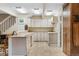 Bright kitchen features ample cabinet space, tile floors, and access to adjacent living spaces at 1051 Independence St, Lakewood, CO 80215