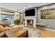 Living room featuring a fireplace, large TV, and comfortable seating at 1051 Independence St, Lakewood, CO 80215