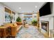 Comfortable living room featuring a fireplace and large windows at 1051 Independence St, Lakewood, CO 80215