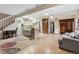 Cozy open-concept living space with tile flooring, adjacent kitchen, and comfortable seating at 1051 Independence St, Lakewood, CO 80215